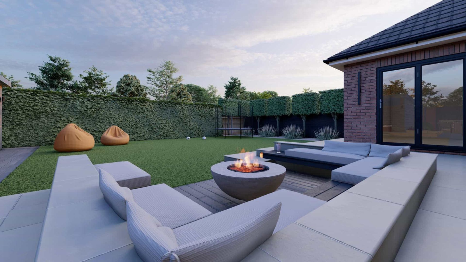 Contemporary garden seating area with built-in grey sofas, a circular fire pit, artificial lawn and clipped hedge screening.