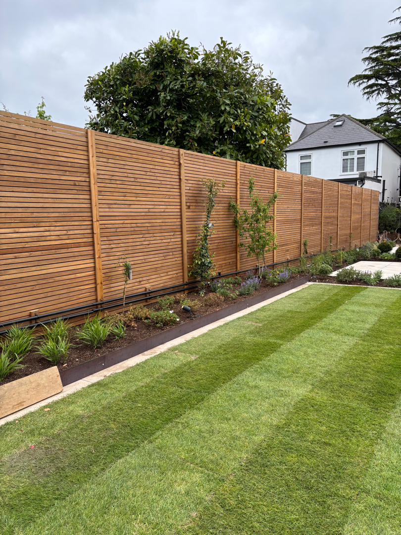 Boundary fencing beside a landscaped garden