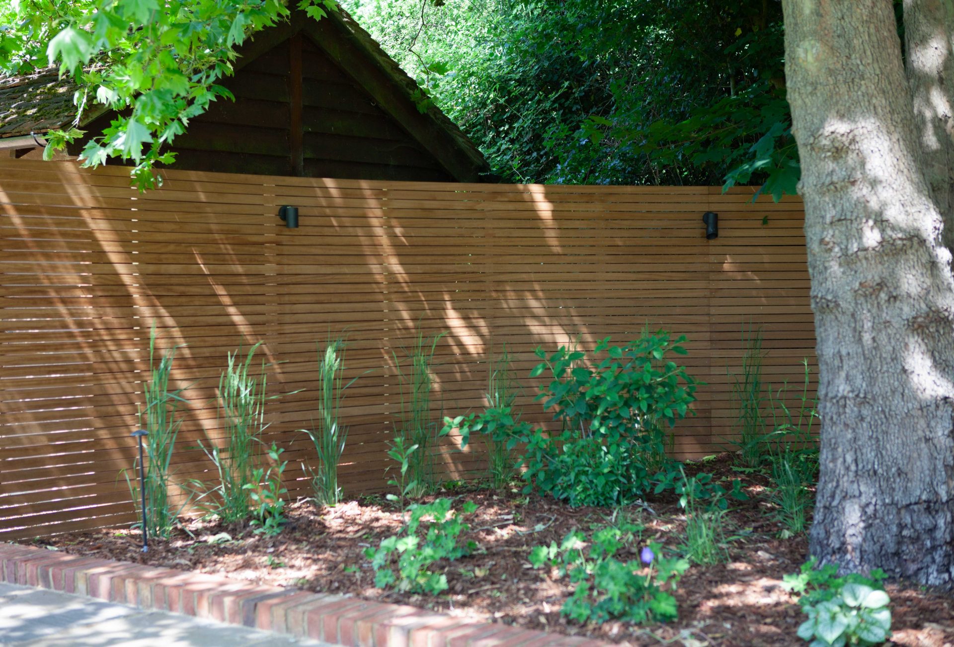 Wide view of the finished Ardley garden for the Stone Terrace & Brick Detail project.