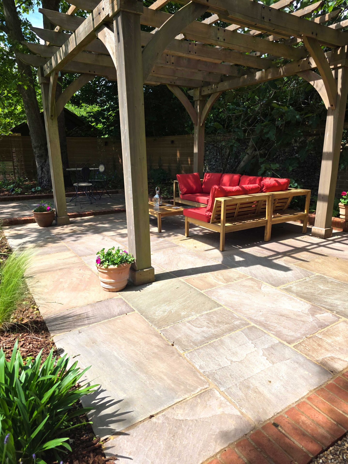 Wide view of the finished Ardley garden for the Stone Terrace & Brick Detail project.