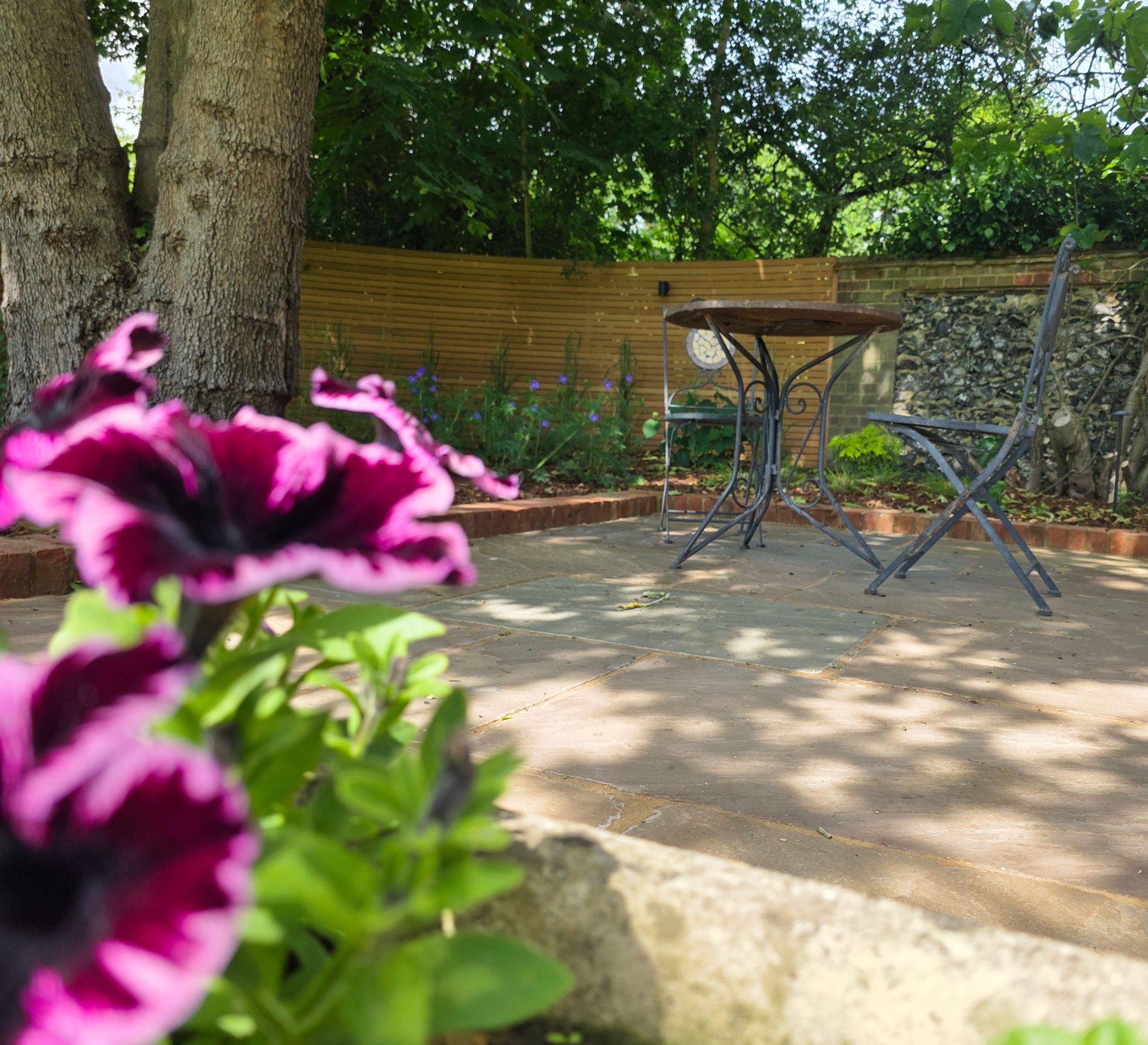 Wide view of the finished Ardley garden for the Stone Terrace & Brick Detail project.