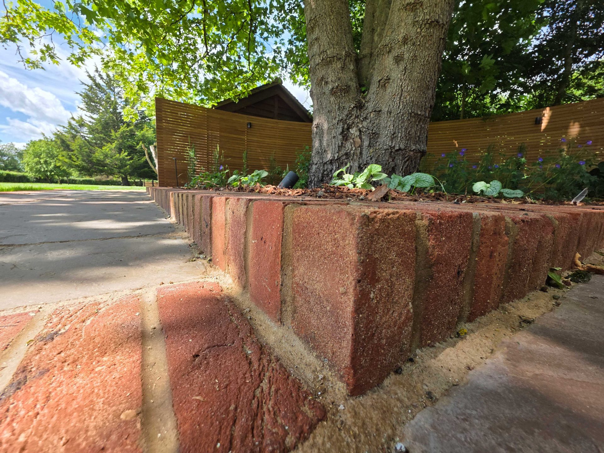 Wide view of the finished Ardley garden for the Stone Terrace & Brick Detail project.