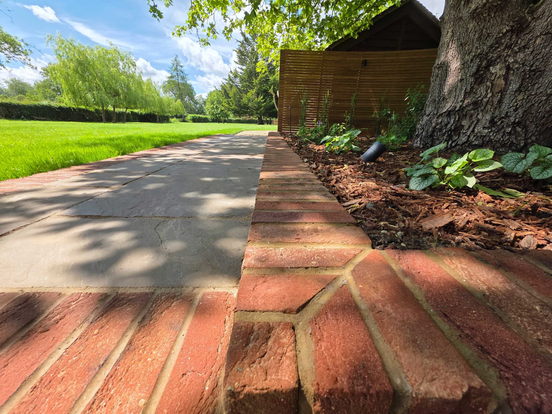 Wide view of the finished Ardley garden for the Stone Terrace & Brick Detail project.