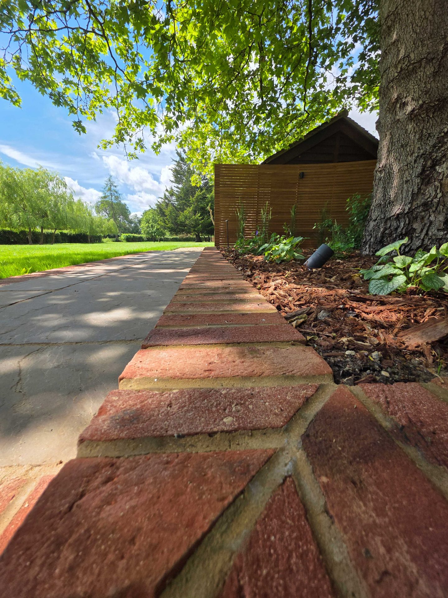 Wide view of the finished Ardley garden for the Stone Terrace & Brick Detail project.