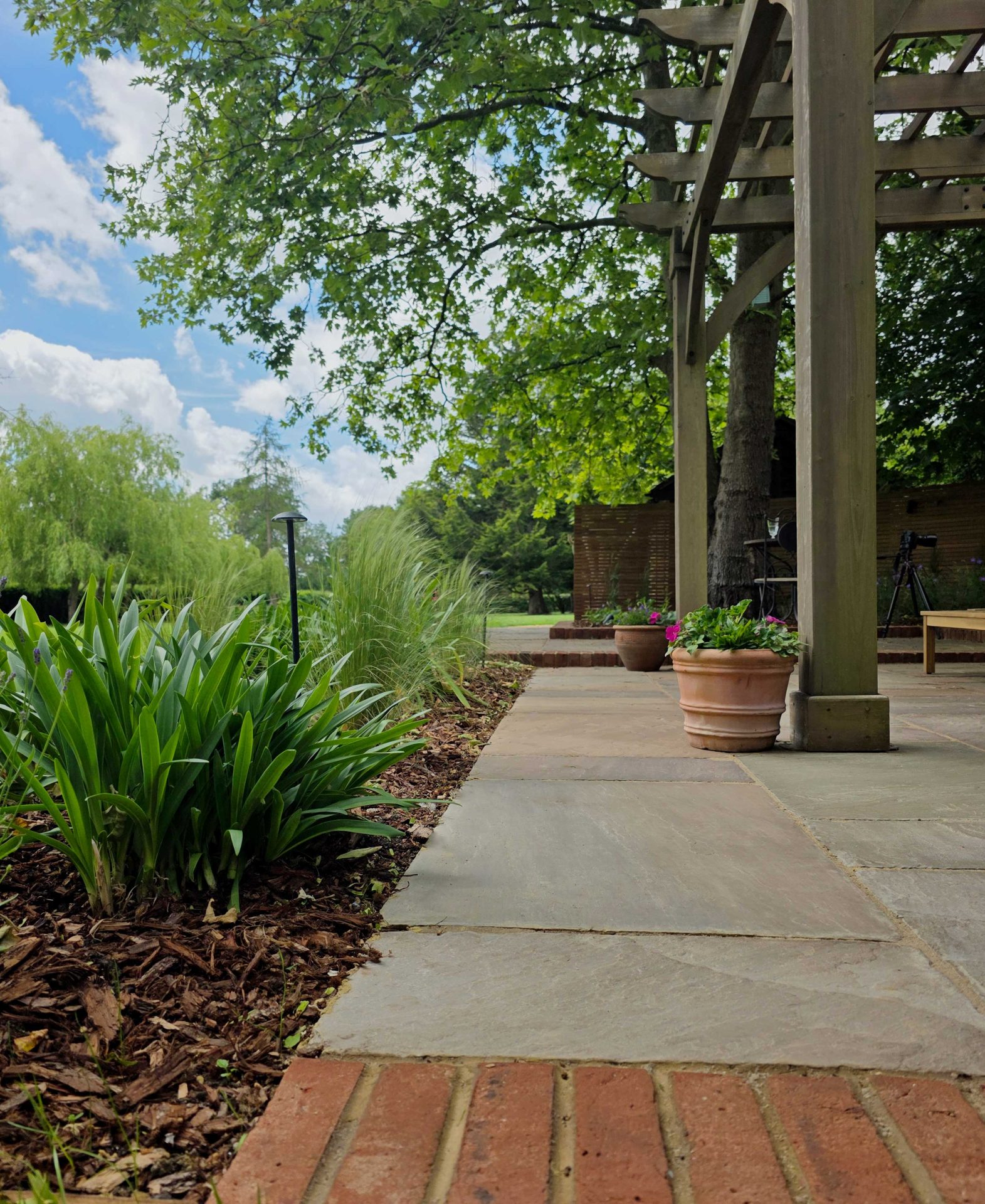 Wide view of the finished Ardley garden for the Stone Terrace & Brick Detail project.