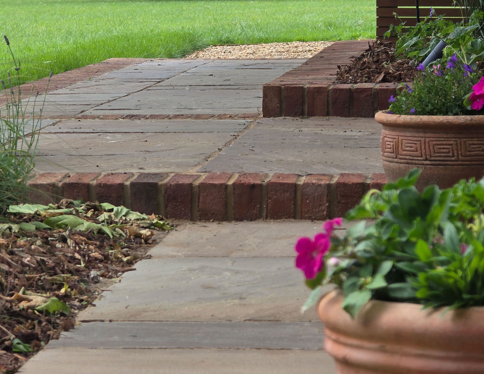 Wide view of the finished Ardley garden for the Stone Terrace & Brick Detail project.