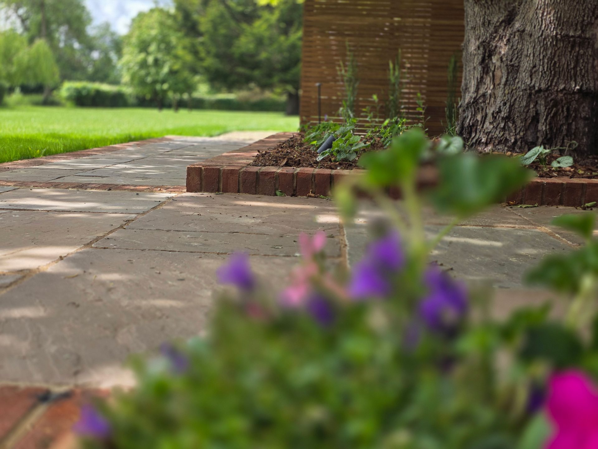 Wide view of the finished Ardley garden for the Stone Terrace & Brick Detail project.