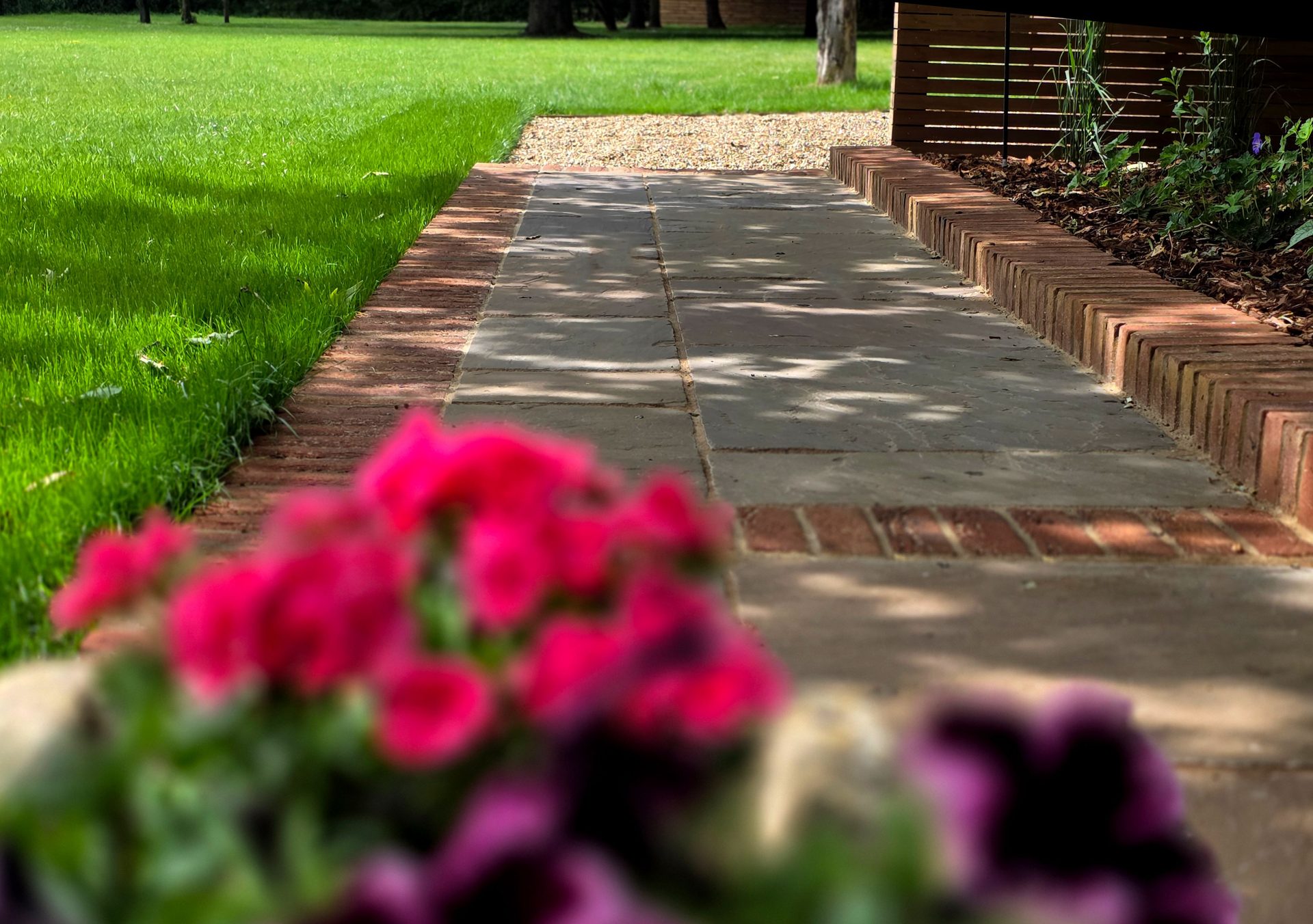 Wide view of the finished Ardley garden for the Stone Terrace & Brick Detail project.