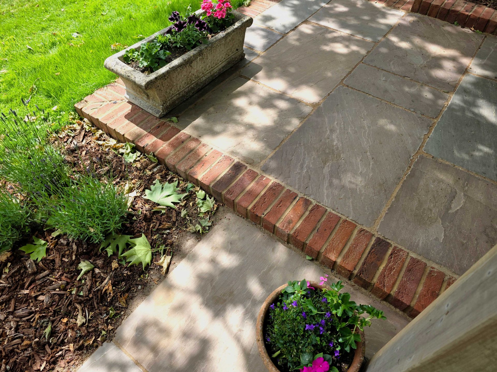 Wide view of the finished Ardley garden for the Stone Terrace & Brick Detail project.