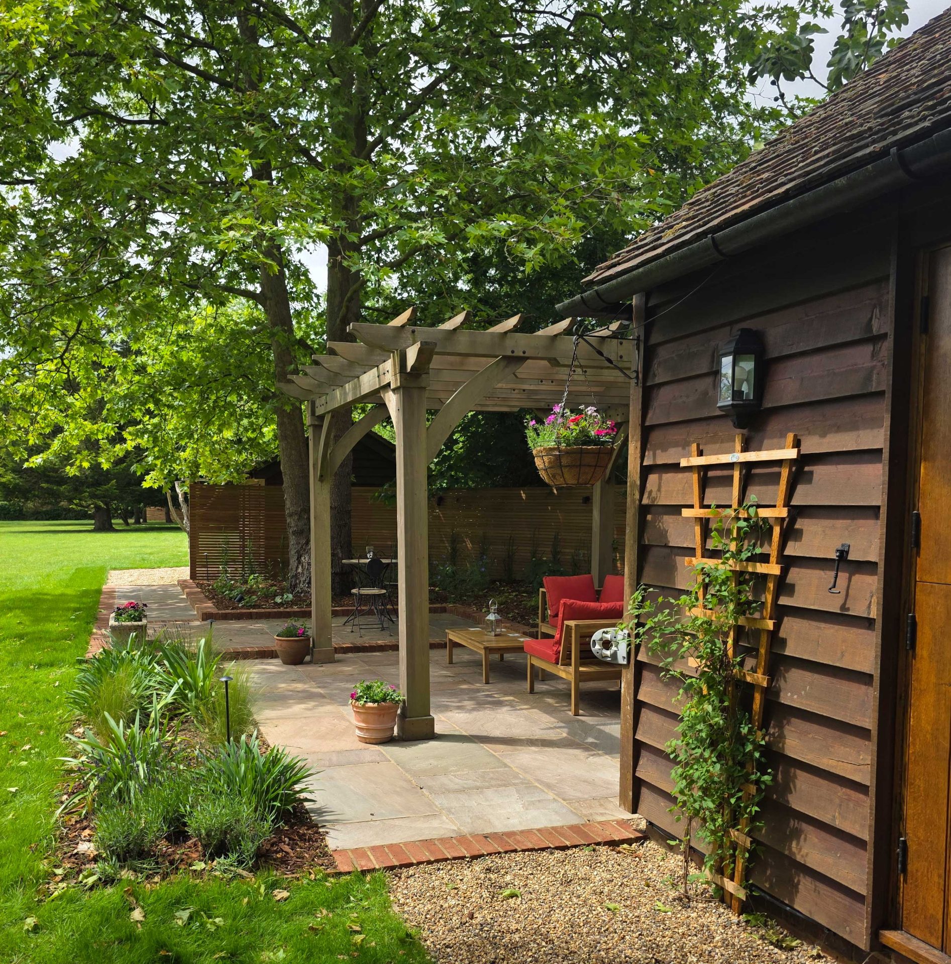 Wide view of the finished Ardley garden for the Stone Terrace & Brick Detail project.