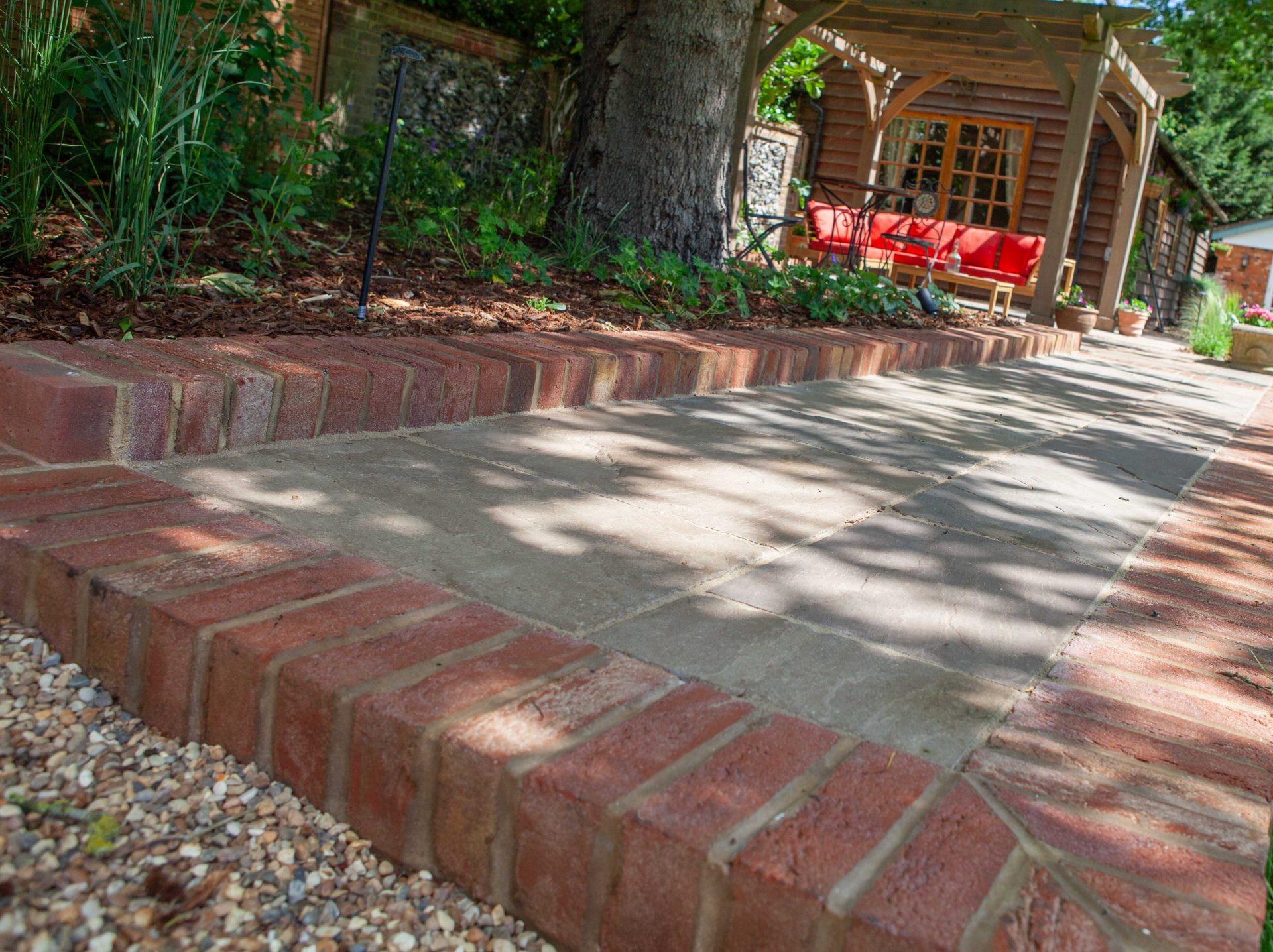 Wide view of the finished Ardley garden for the Stone Terrace & Brick Detail project.